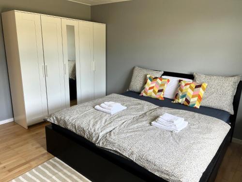 a bedroom with a bed with towels on it at Waves & Waterslides in Rødby