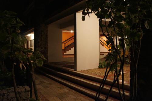a staircase leading to a house at night at Hotel Maya Tucan in Palenque