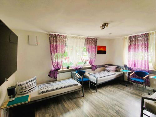 a room with two beds and pink curtains at Ferienhaus Bailey in Laupheim