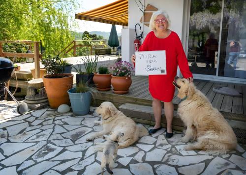 a woman is holding a sign next to two dogs at Peaceful Countryside Getaway in Parbayse