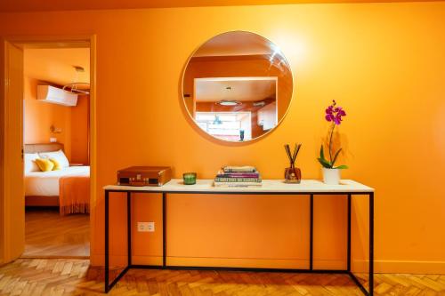 a room with a table and a mirror at Cascais Cosy Home - Rooms with Private Bathroom in Cascais