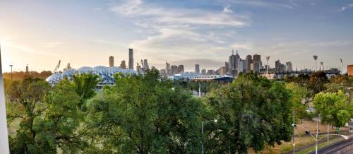 a view of a city skyline with trees in the foreground at 381 Cremorne in Melbourne