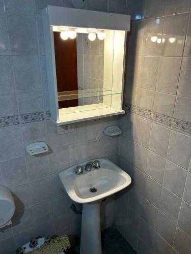 a bathroom with a sink and a mirror at cabañas Villa de las rosas in Villa de Las Rosas