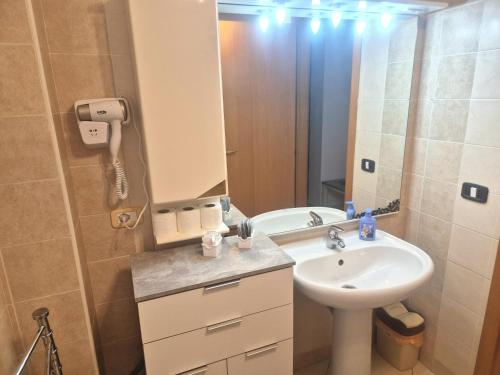 a bathroom with a sink and a mirror at Via Pasquale Testa in Formia