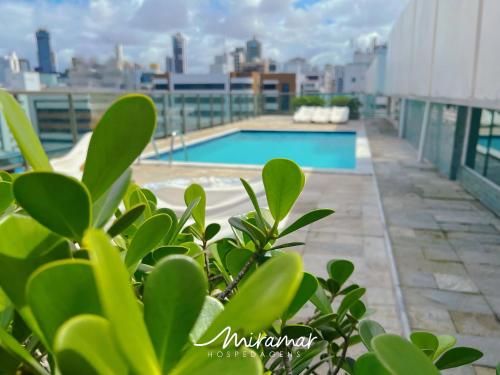 a view of the pool on the roof of a building at Tambaú Home Service - Miramar Hospedagens in Tambaú
