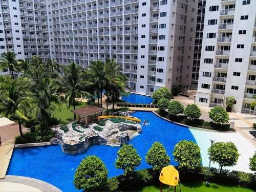 an aerial view of a resort with blue water at SLY Staycation at Shore Residences Mall of Asia in Manila