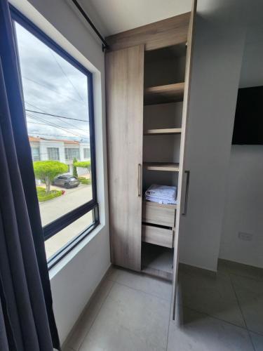 a room with a window and a ladder at Apartaestudio 301 moderno y unico in Tuluá