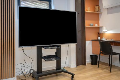 Una televisión o centro de entretenimiento en La Porte des Alpes chambres d'hôtes