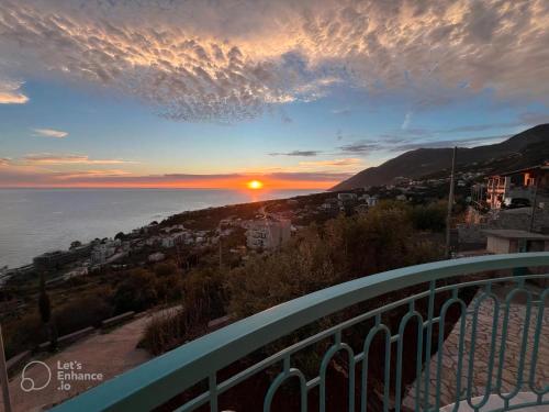 a view of the sunset from a balcony at Endless blue Apartments in Dhërmi