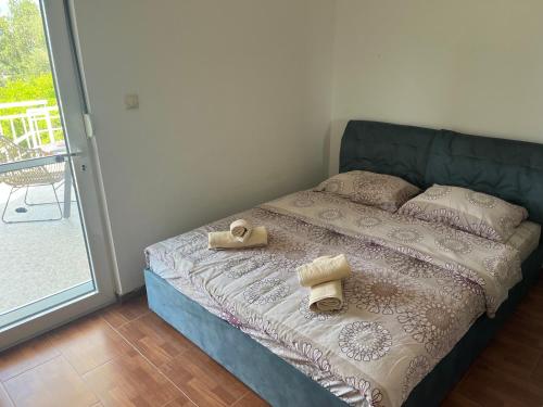 a bedroom with a bed with two towels on it at Vila Natalia in Petrovac na Moru