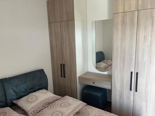 a bedroom with a bed and a mirror at Vila Natalia in Petrovac na Moru