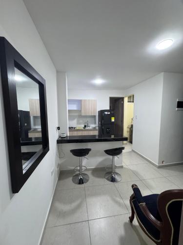 a kitchen with a table and a mirror in a room at Apartaestudio 301 moderno y unico in Tuluá