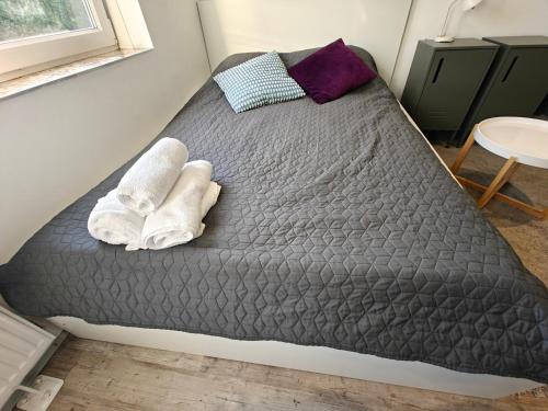 a bedroom with a bed with towels on it at Southern Sun in Tilburg