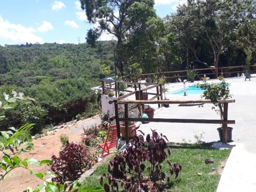 a view of a swimming pool from a garden at Espaço Azul in Ibiúna