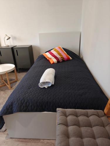 a bedroom with a bed and a pillow and a table at Southern Sun in Tilburg