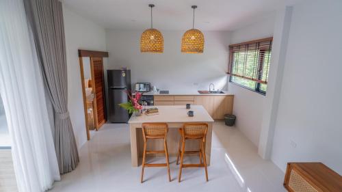a kitchen with a table and two chairs at Baan View Talay Pool Villas in Thong Nai Pan Yai