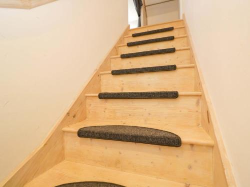 a staircase in a house with wooden steps at Barn Cottage in Frome