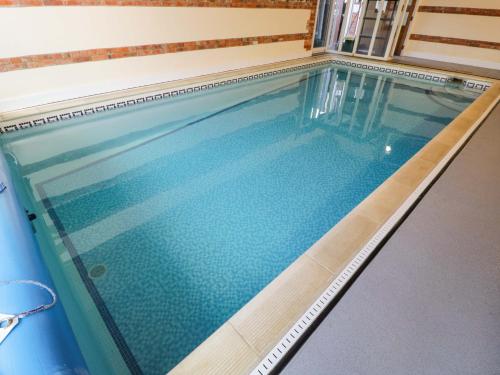 an empty swimming pool in a house at Barn Cottage in Frome