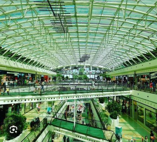 a large shopping mall with a glass ceiling at Joana's room 1 in Lisbon