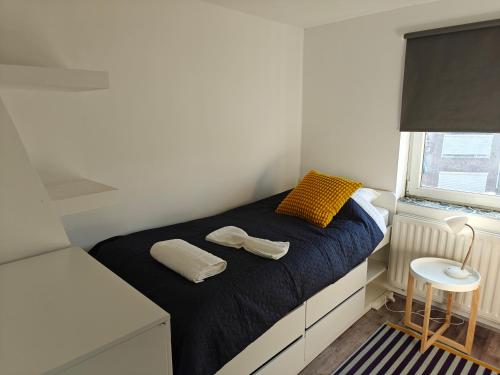 a small bedroom with a bed and a window at Southern Sun in Tilburg
