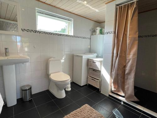 a bathroom with a toilet and a sink at 4 star holiday home in SÖLVESBORG in Sölvesborg