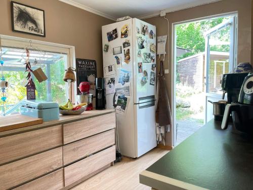 a kitchen with a refrigerator with many pictures on it at 6 person holiday home in HÖRBY in Hörby