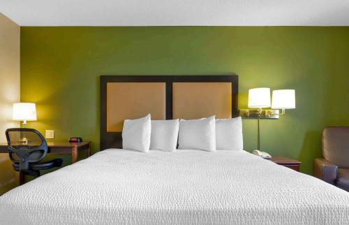 a hotel room with a bed and a chair at Extended Stay America Suites - Austin - Southwest in Austin