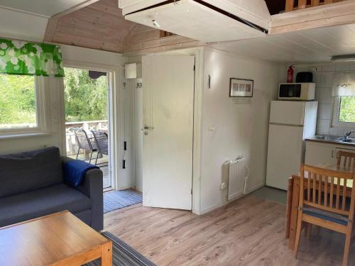 a living room with a couch and a table at 4 person holiday home in SENOREN in Möcklö