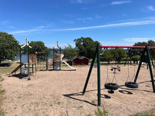 an empty playground with two swings at 4 person holiday home in SENOREN in Möcklö