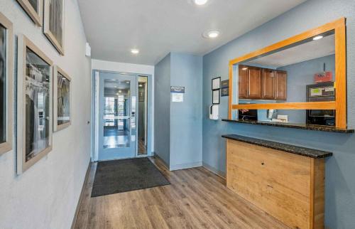 a kitchen with a counter and a mirror on the wall at Extended Stay America Select Suites - Indianapolis - Lawrence in Fishers