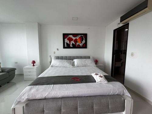 a white bedroom with a large bed in it at Scherezade Hotel&Resorts in Aguachica