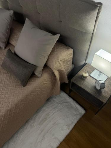 a bedroom with a bed with a side table with a lamp at Aria B&B - apartment in the historic center in Spoleto