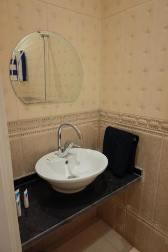 a bathroom with a sink and a mirror on a counter at Andalusia Blue Beach Hurghada in Hurghada