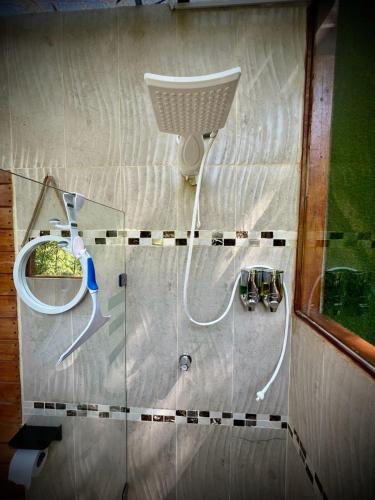 a view of a shower in a bathroom with a mirror at Hospedaje Curiquindi - Mindo Eco Lodge in Mindo