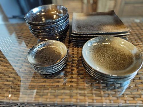 three stacks of plates sitting on top of a table at 風の音 in Motobu