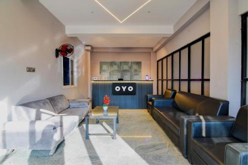 a living room with couches and a table at Hotel O Neatflix &Chill in Khandagiri