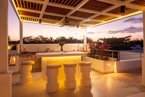 an outdoor kitchen with a bar on a roof at New Beachfront Penthouse Punta Popy in Las Terrenas