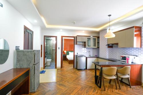 a kitchen with a table and chairs in a room at Mama Hotel And Apartment - Free Sauna And Gym in Da Nang