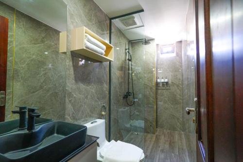 a bathroom with a sink and a shower at Mama Hotel And Apartment - Free Sauna And Gym in Da Nang