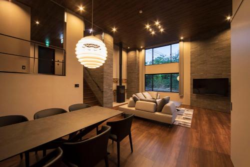 a living room with a table and a couch at COCO VILLA 那須高原-Sauna- in Nasu