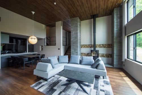 a living room with a couch and a table at COCO VILLA 那須高原-Sauna- in Nasu