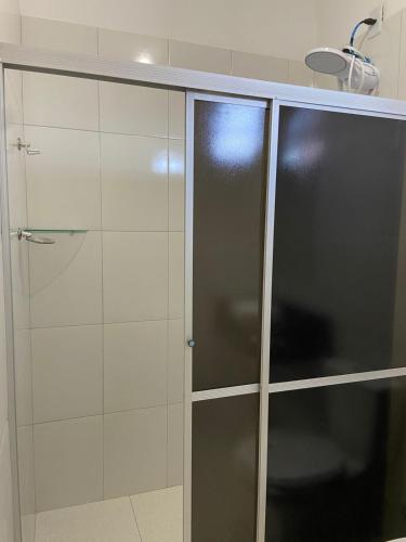 a shower with glass doors in a bathroom at Pousada BG Lençóis in Barreirinhas