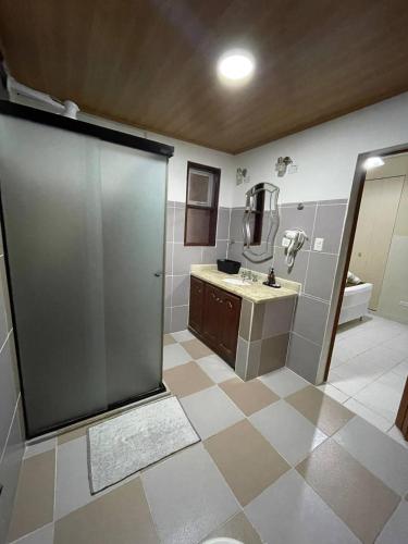 a bathroom with a large shower and a sink at Gaman Hotel Glamping in Santa Cruz de la Sierra