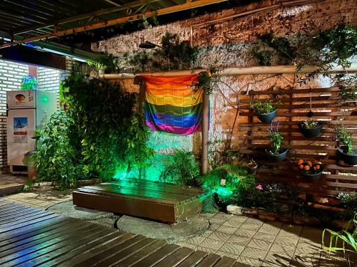 a garden with a rainbow curtain and plants at Zizi Home Vibes in Chapada dos Guimarães