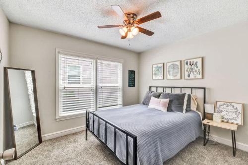 a bedroom with a bed and a ceiling fan at Pecan Hill House in Waco