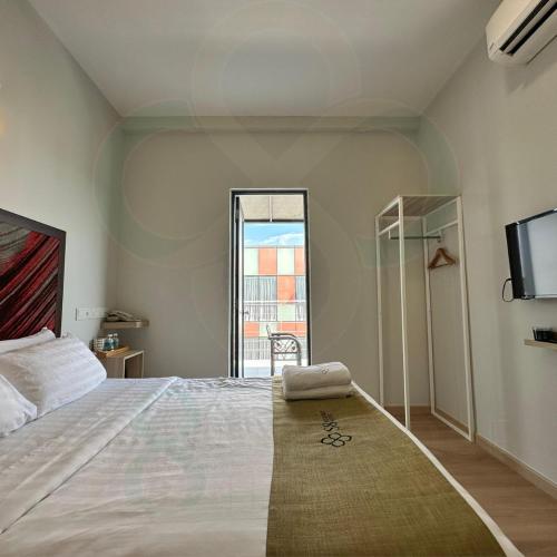 a bedroom with a large bed and a tv at S8 Boutique Hotel near KLIA 1 & KLIA 2 in Sepang