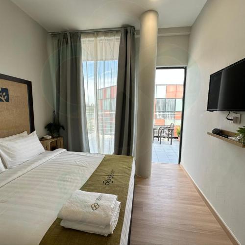 a bedroom with a large bed and a large window at S8 Boutique Hotel near KLIA 1 & KLIA 2 in Sepang