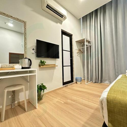a bedroom with a bed and a desk and a mirror at S8 Boutique Hotel near KLIA 1 & KLIA 2 in Sepang