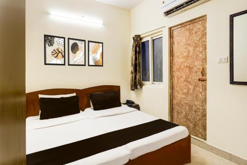 a bedroom with a bed and a window at Collection O Thousand Lights Chennai in Chennai