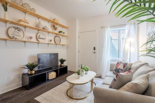 a living room with a couch and a tv at Large Suite in Downtown Montreal in Montréal